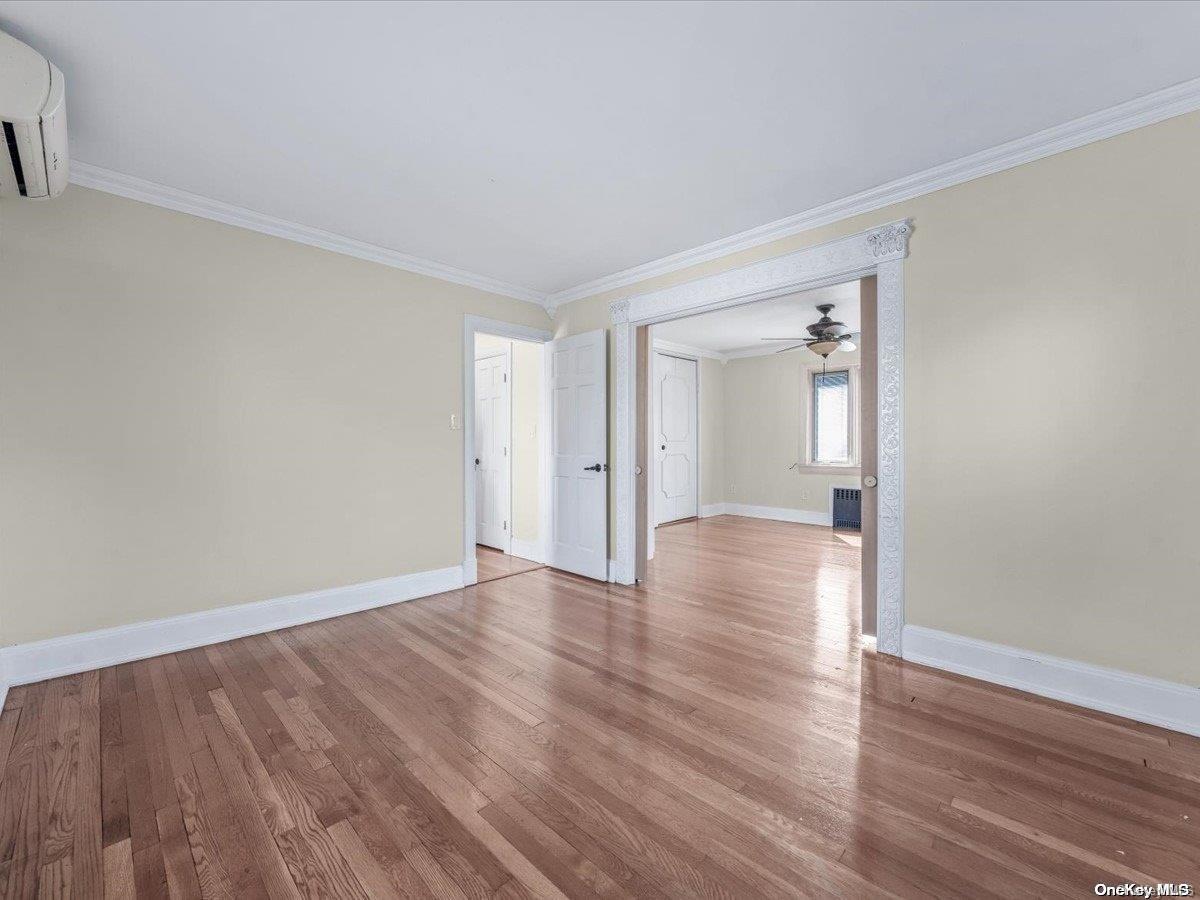33-71 161st Street Queens, NY 11358 - Photo 16 of 35 a view of wooden floor and windows in a room
