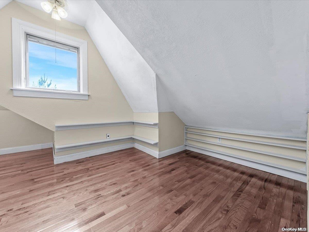 33-71 161st Street Queens, NY 11358 - Photo 23 of 35 a view of an empty room with wooden floor and a window