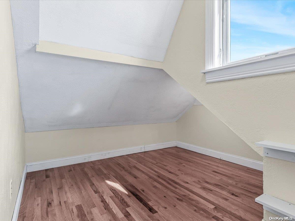 33-71 161st Street Queens, NY 11358 - Photo 24 of 35 a view of a room that has wooden floor and small window