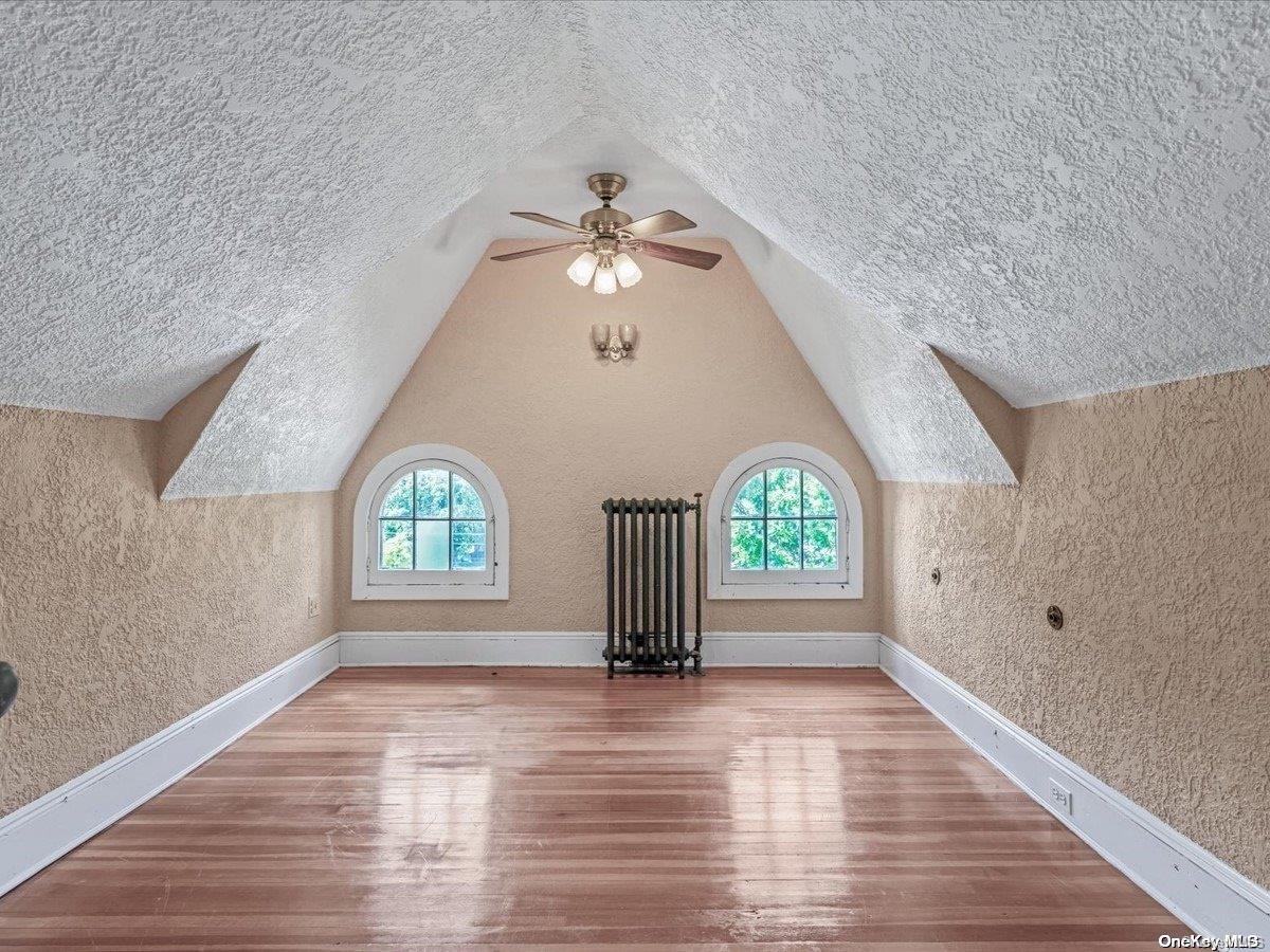 33-71 161st Street Queens, NY 11358 - Photo 25 of 35 wooden floor in an empty room with a window