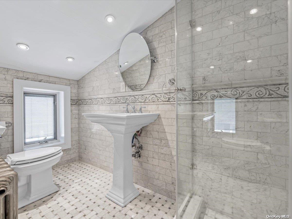 33-71 161st Street Queens, NY 11358 - Photo 26 of 35 a bathroom with a toilet a sink and mirror