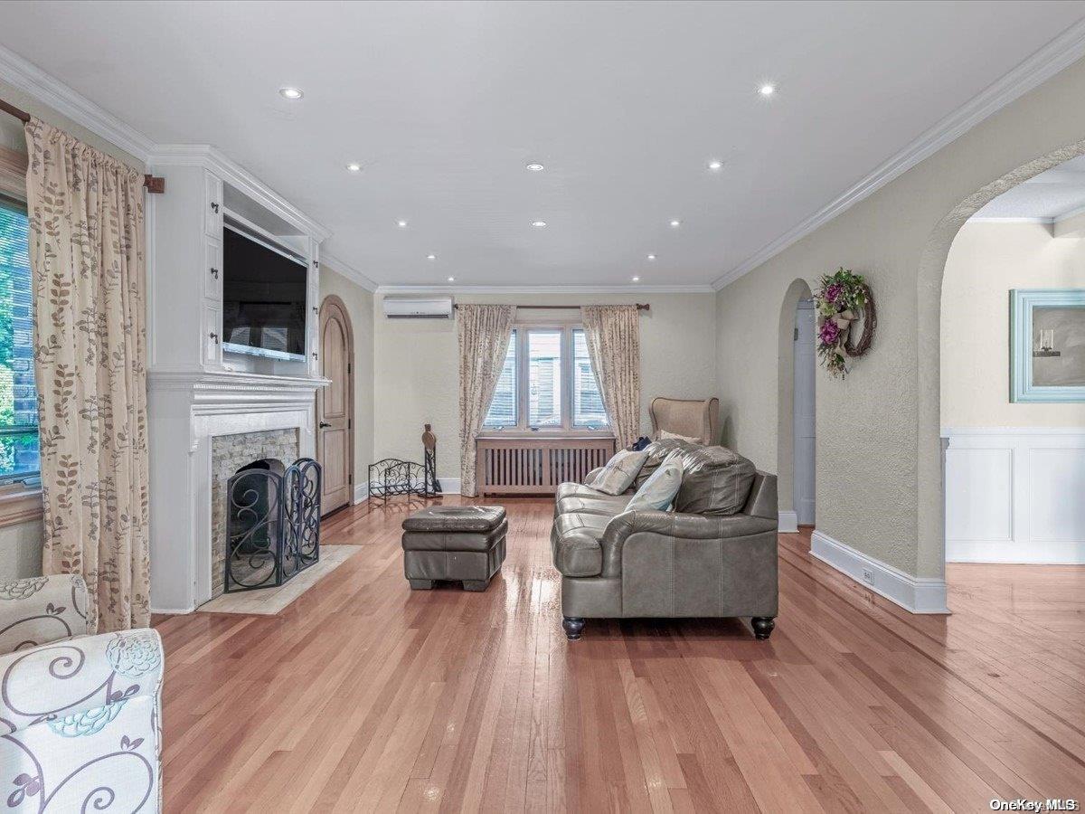 33-71 161st Street Queens, NY 11358 - Photo 3 of 35 a living room with furniture and a fireplace