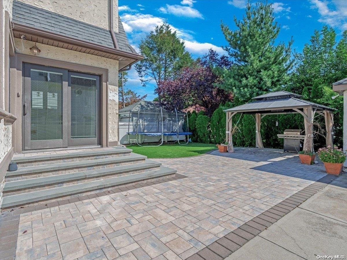 33-71 161st Street Queens, NY 11358 - Photo 33 of 35 a view of a house with sitting area and a yard