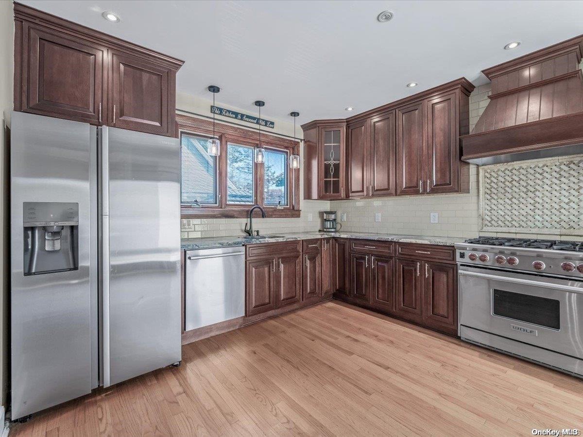 33-71 161st Street Queens, NY 11358 - Photo 7 of 35 a kitchen with a sink cabinets stainless steel appliances and a window