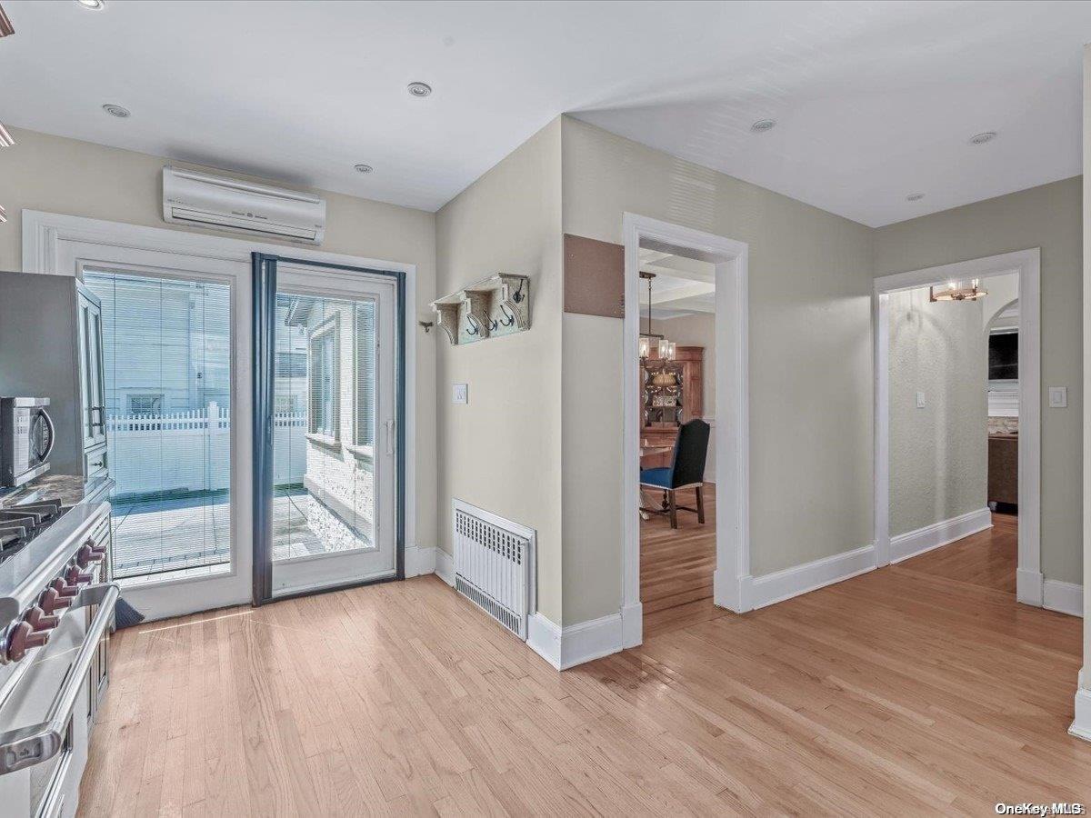 33-71 161st Street Queens, NY 11358 - Photo 10 of 35 an empty room with wooden floor and a bathroom