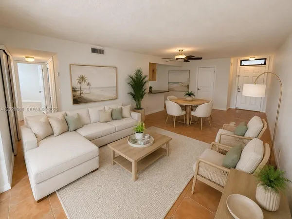 a living room with furniture and a chandelier