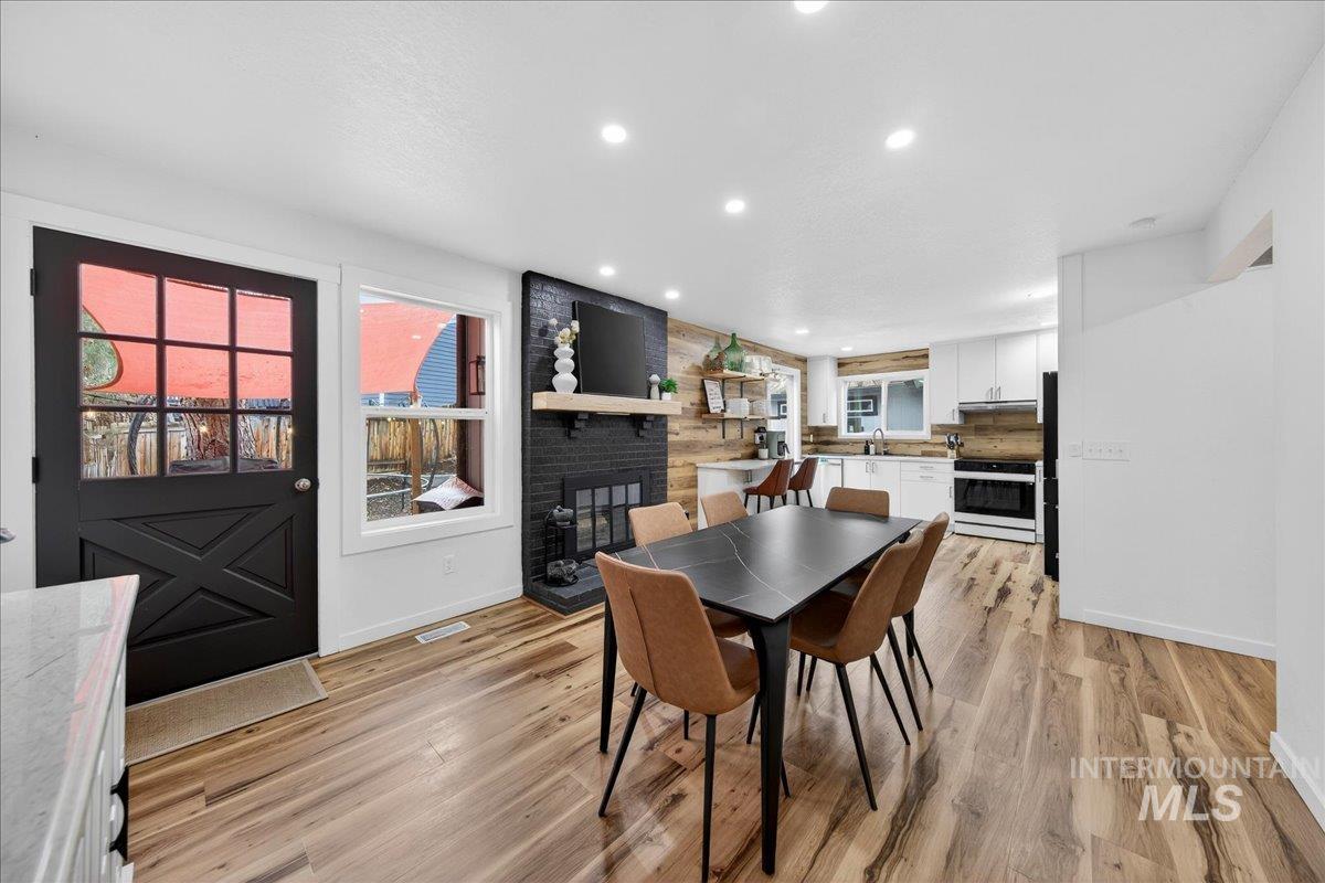 760 Meaghan Place Boise, ID 83712 - Photo 13 of 38 Dining space with a fireplace, light wood-style flooring, and recessed lighting