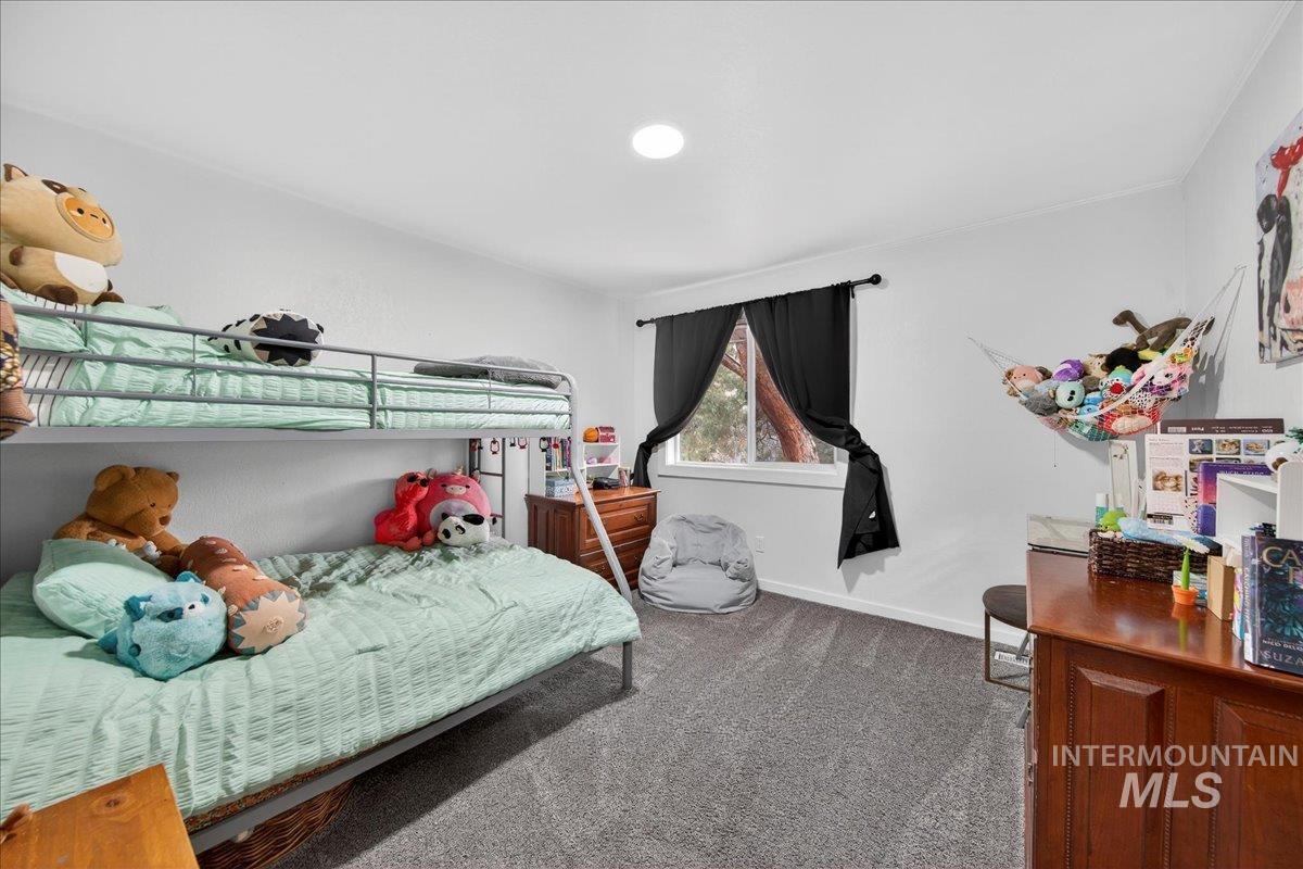 760 Meaghan Place Boise, ID 83712 - Photo 21 of 38 Bedroom featuring dark colored carpet and baseboards