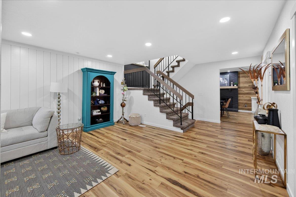 760 Meaghan Place Boise, ID 83712 - Photo 6 of 38 Living area featuring a fireplace, wood finished floors, recessed lighting, and wood walls