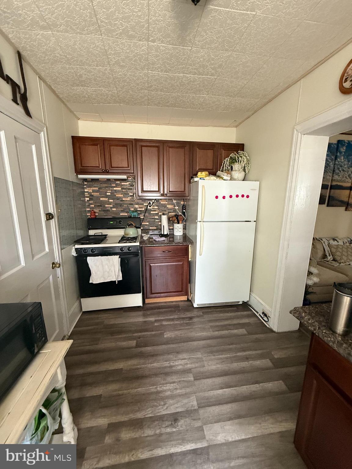 923 Walnut Street, Unit 1 Royersford, PA 19468 - Photo 11 of 14 a kitchen with wooden cabinets and white appliances