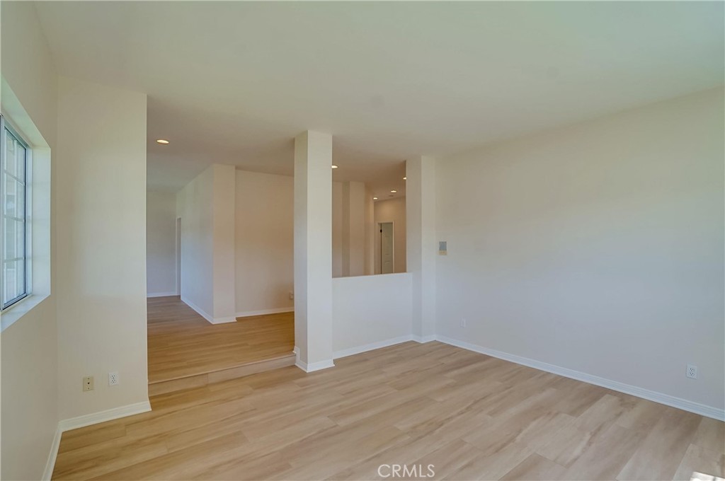 19614 Darien Place Torrance, CA 90503 - Photo 11 of 72 a view of an empty room with wooden floor and a window
