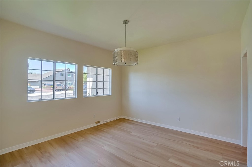 19614 Darien Place Torrance, CA 90503 - Photo 13 of 72 an empty room with wooden floor and windows