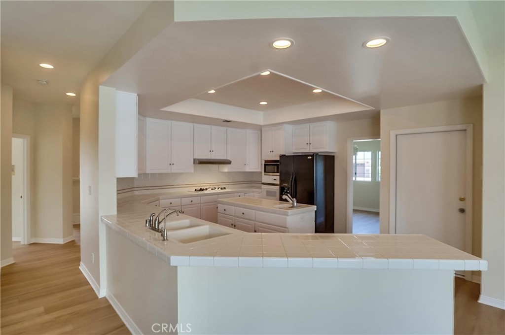 19614 Darien Place Torrance, CA 90503 - Photo 17 of 72 a kitchen with stainless steel appliances granite countertop a sink and a refrigerator