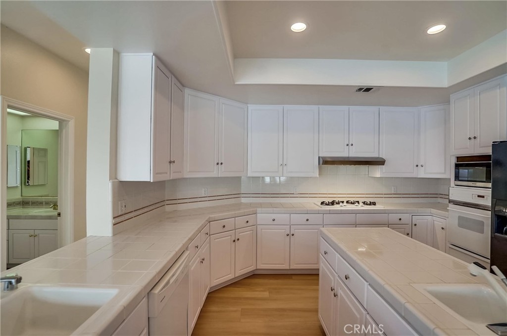 19614 Darien Place Torrance, CA 90503 - Photo 23 of 72 a kitchen with cabinets appliances a sink and a counter top