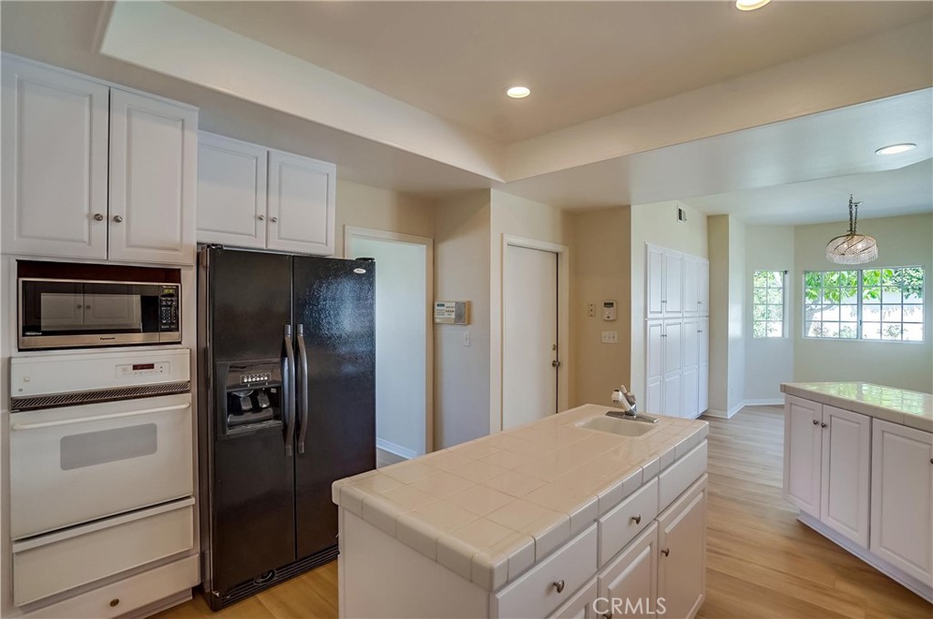 19614 Darien Place Torrance, CA 90503 - Photo 24 of 72 a kitchen with stainless steel appliances a refrigerator sink and cabinets