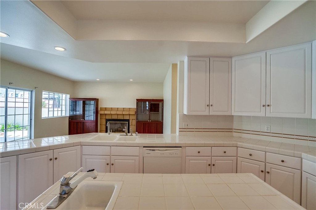 19614 Darien Place Torrance, CA 90503 - Photo 26 of 72 a kitchen with white cabinets and sink