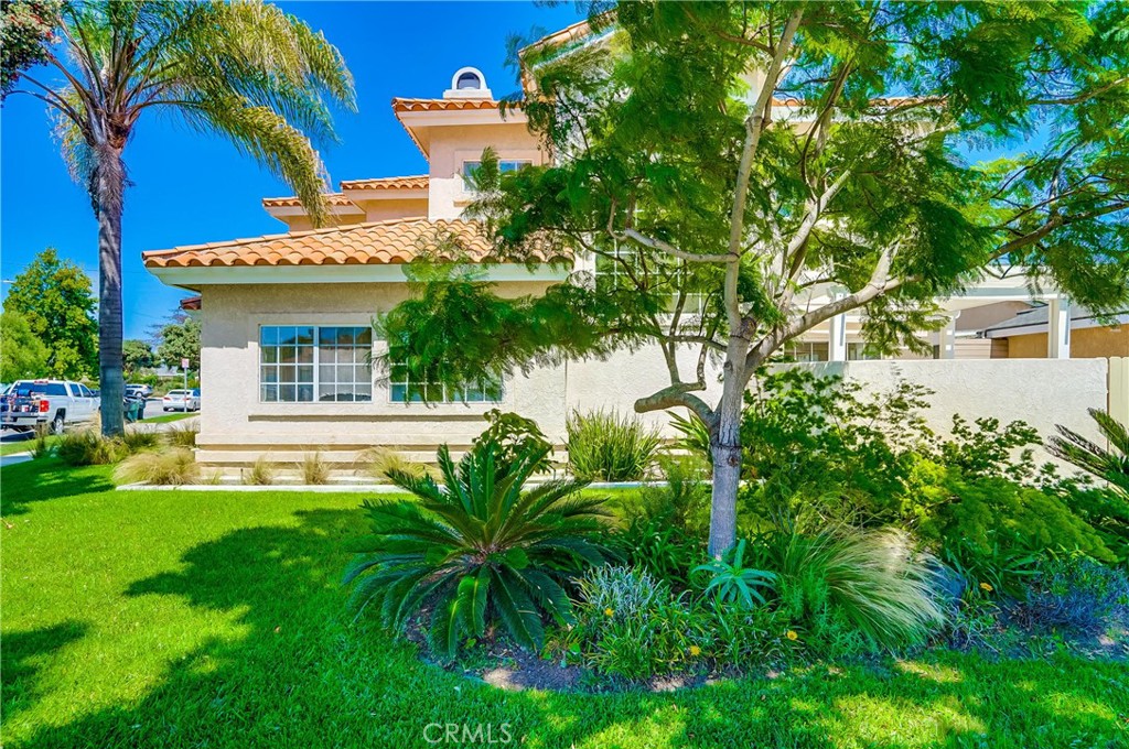 19614 Darien Place Torrance, CA 90503 - Photo 3 of 72 a view of a house with a small yard plants and a large tree