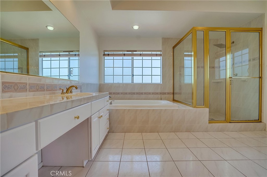 19614 Darien Place Torrance, CA 90503 - Photo 33 of 72 a spacious bathroom with a granite countertop sink a mirror and a bathtub