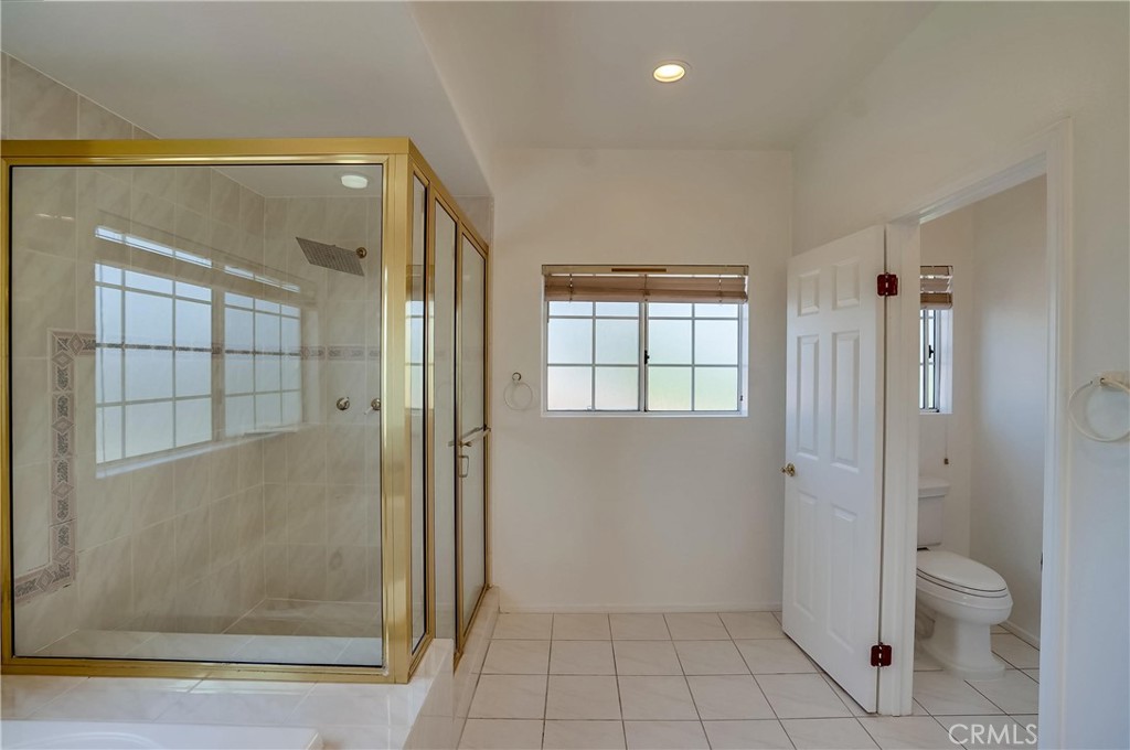 19614 Darien Place Torrance, CA 90503 - Photo 35 of 72 a bathroom with a glass shower door and a toilet