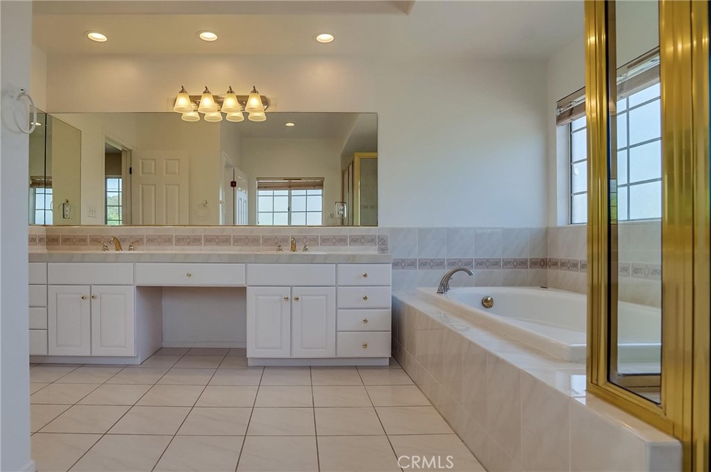19614 Darien Place Torrance, CA 90503 - Photo 36 of 72 a spacious bathroom with a granite countertop sink a large mirror and bathtub