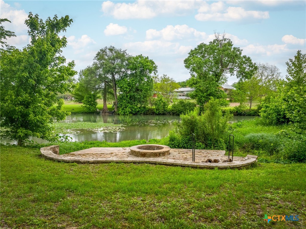 114 River Ranch Circle Martindale, TX 78655 - Photo 14 of 17 a view of a lake with a house in the background