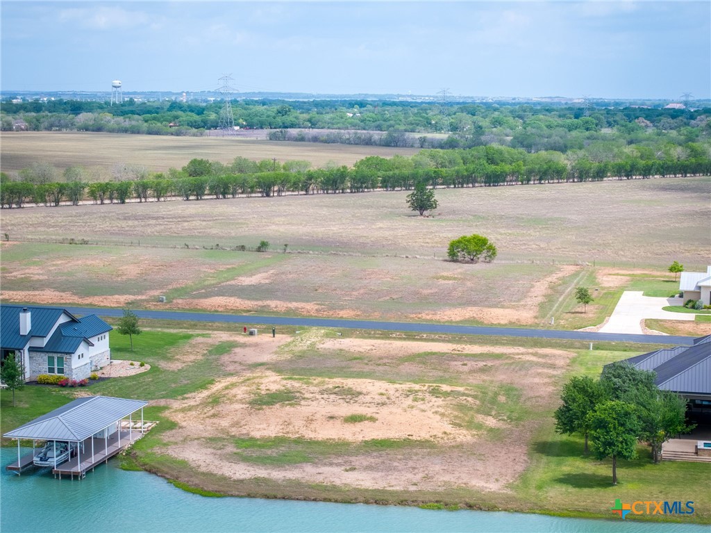 114 River Ranch Circle Martindale, TX 78655 - Photo 5 of 17 a view of a lake with lawn chairs and large trees