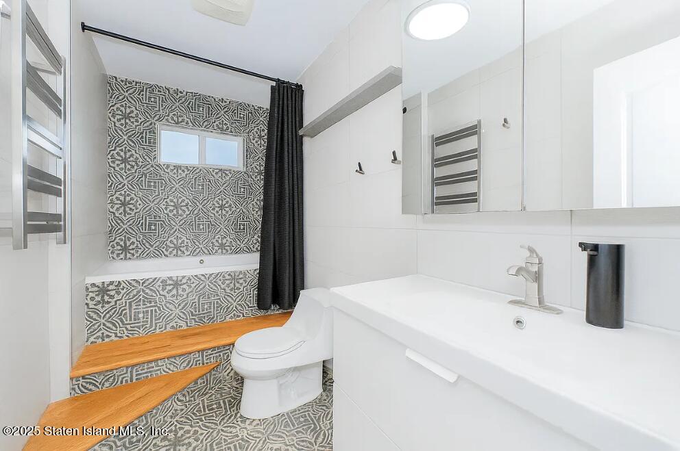 18 Atmore Place Staten Island, NY 10306 - Photo 11 of 19 a bathroom with a sink a toilet and shower