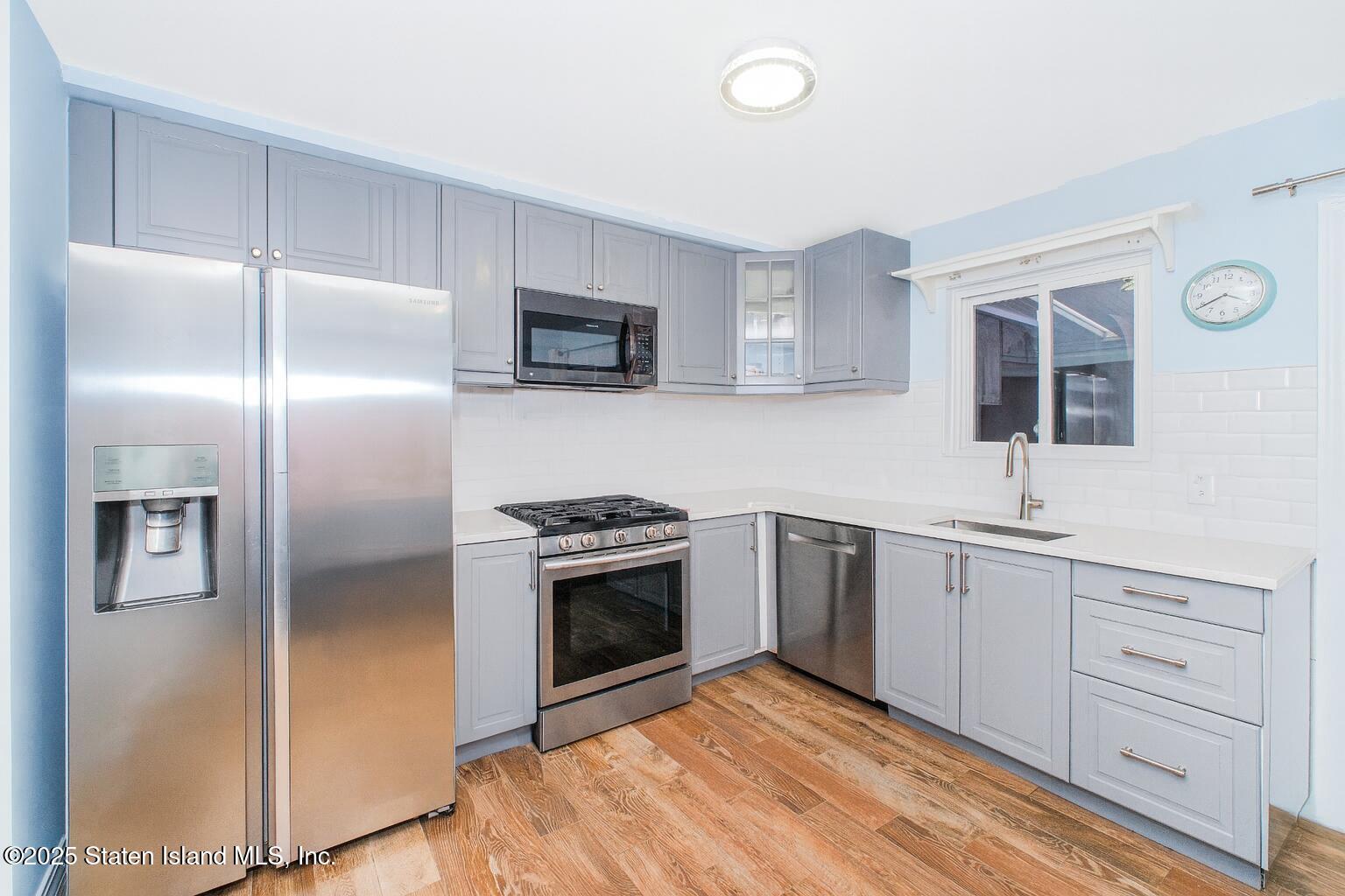 18 Atmore Place Staten Island, NY 10306 - Photo 4 of 19 a kitchen with cabinets stainless steel appliances and sink