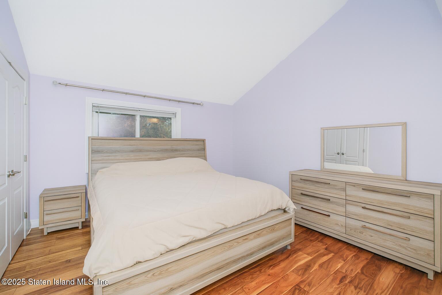 18 Atmore Place Staten Island, NY 10306 - Photo 6 of 19 a bedroom with a bed and a dresser