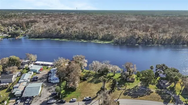 an aerial view of a house with a lake view