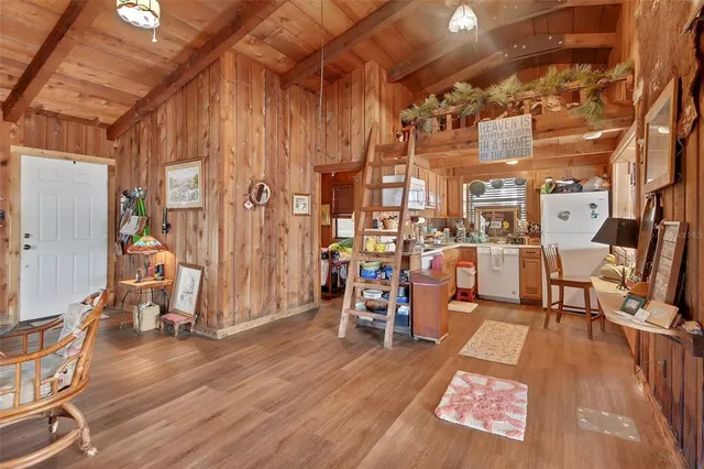 a view of a room with lots of wooden furniture