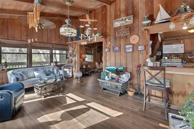 a living room with lots of furniture and chandelier