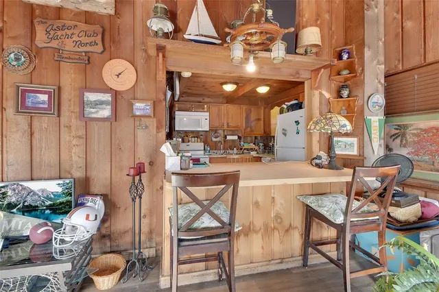a dining area with furniture and a clock