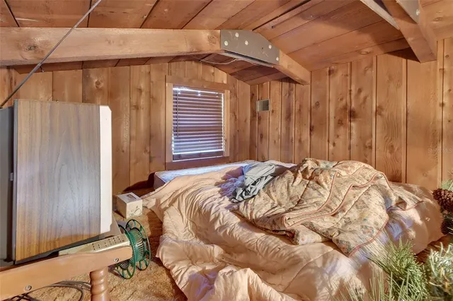 a bed sitting in a bedroom next to a wooden door