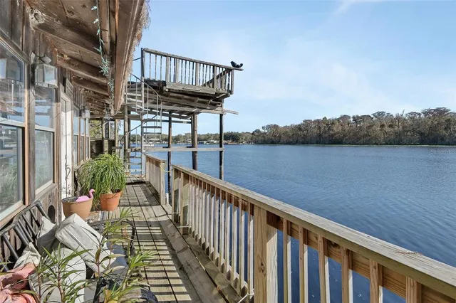 a view of balcony with wooden floor and outdoor seating