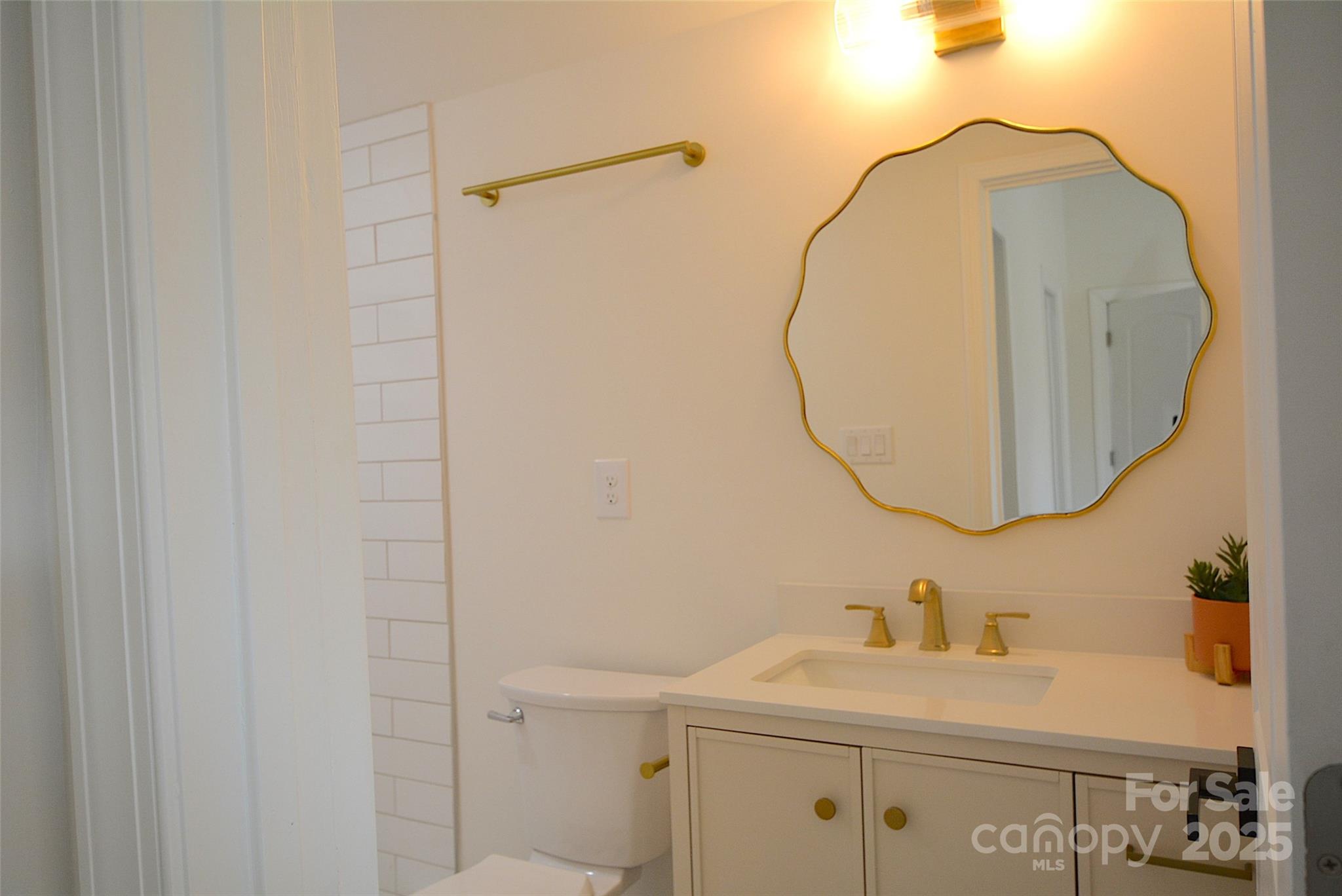 62 Fourth Street Cramerton, NC 28032 - Photo 13 of 26 a bathroom with a sink and a mirror