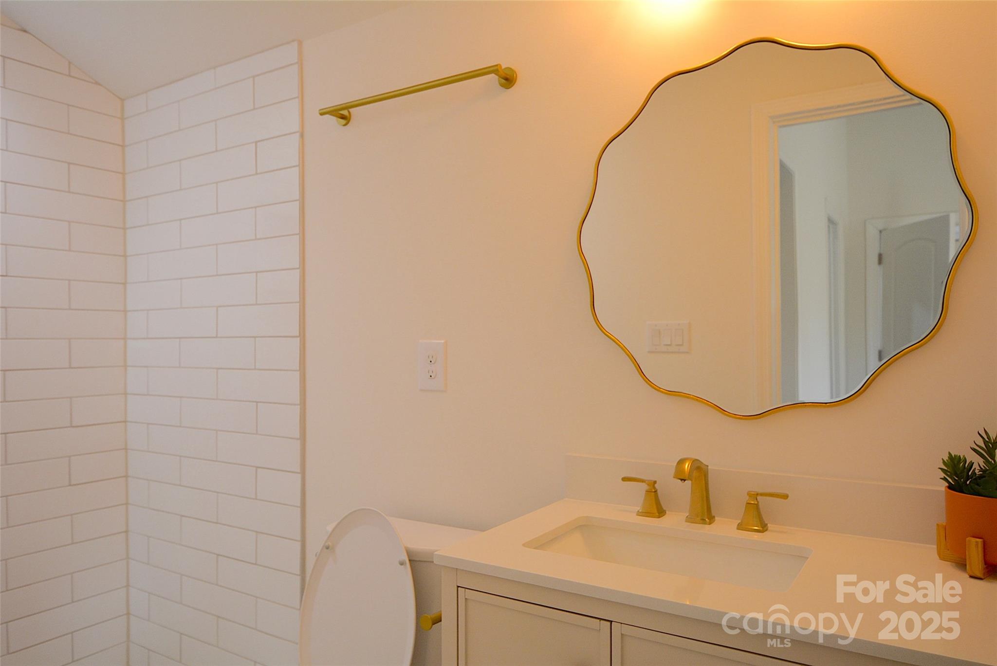 62 Fourth Street Cramerton, NC 28032 - Photo 15 of 26 a bathroom with a sink and a mirror