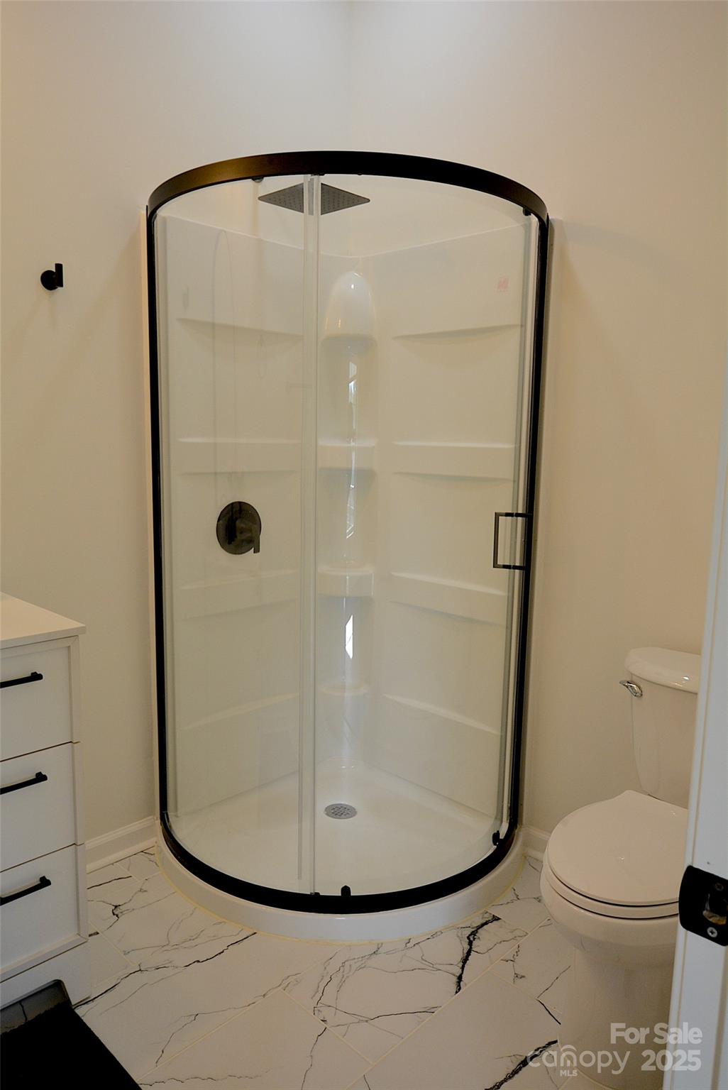 62 Fourth Street Cramerton, NC 28032 - Photo 19 of 26 a bathroom with a glass shower door