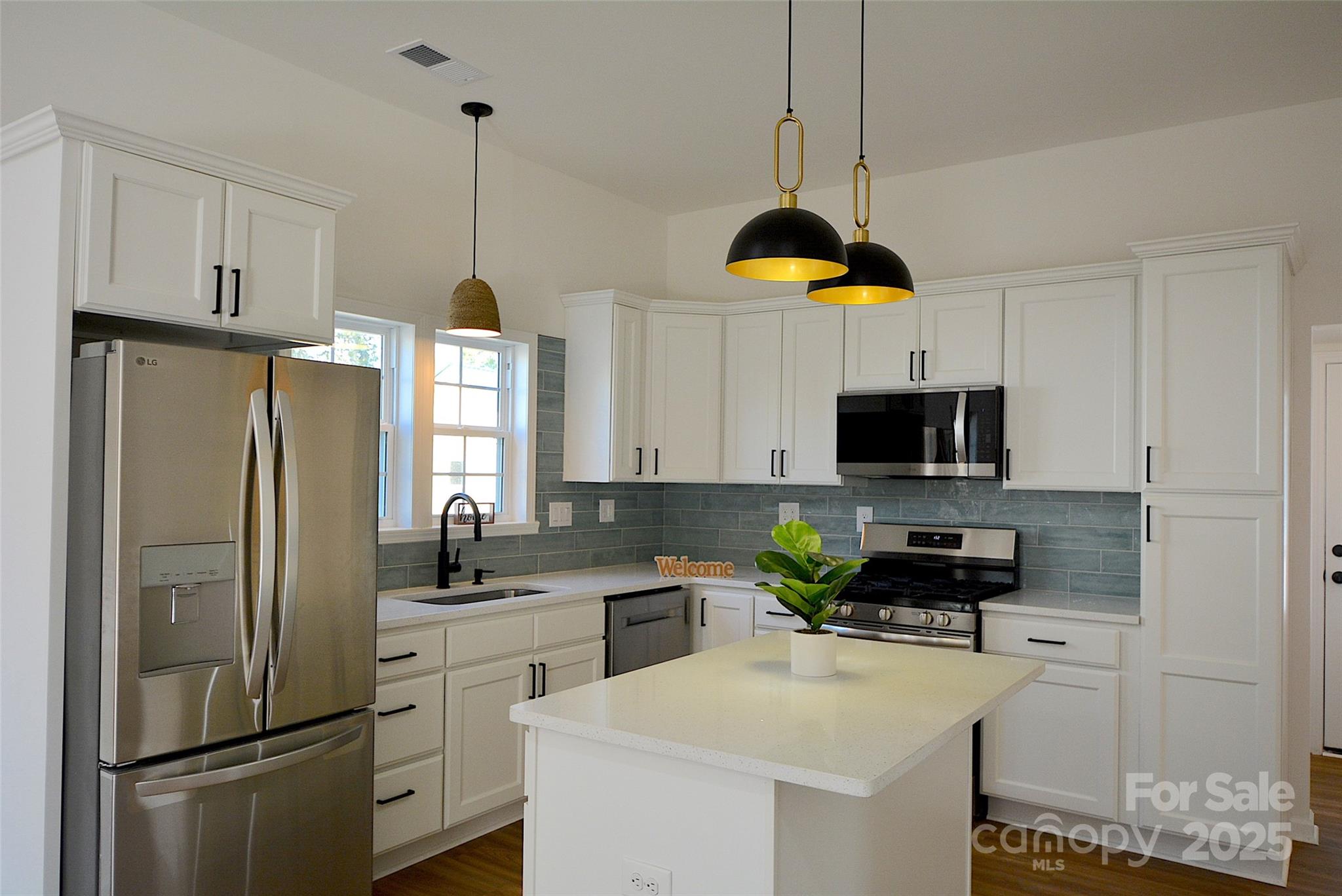 62 Fourth Street Cramerton, NC 28032 - Photo 5 of 26 a kitchen with appliances a sink and cabinets