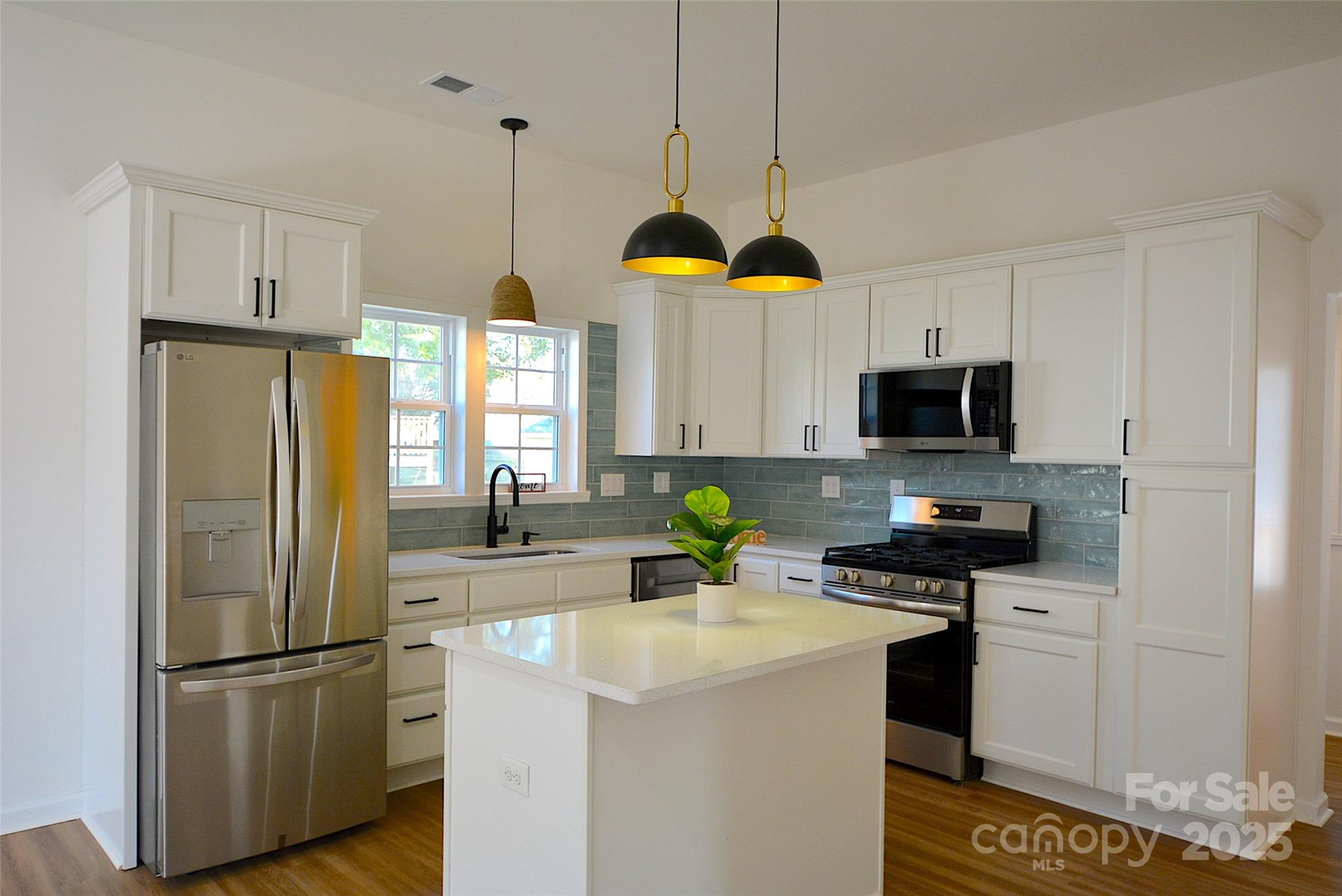 62 Fourth Street Cramerton, NC 28032 - Photo 7 of 26 a kitchen with stainless steel appliances granite countertop a refrigerator a stove a microwave and a sink