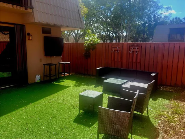 a view of a chair and table in the backyard