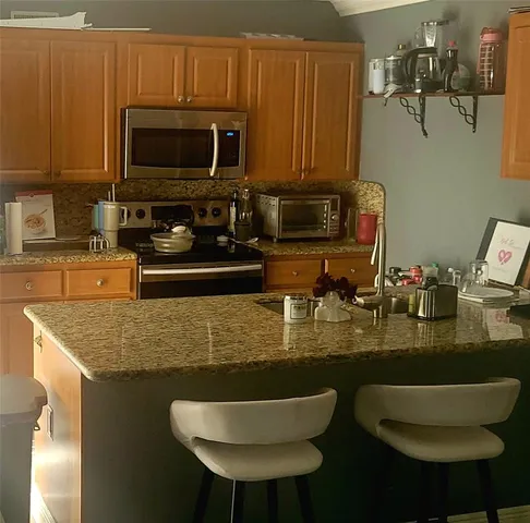 a kitchen with a table chair and fireplace