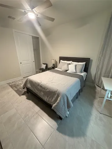 a bedroom with a bed and a lamp