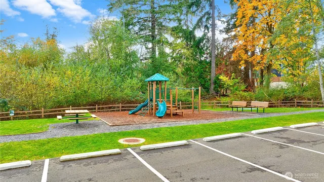 a view of a hallway with wooden floor and a potted plant