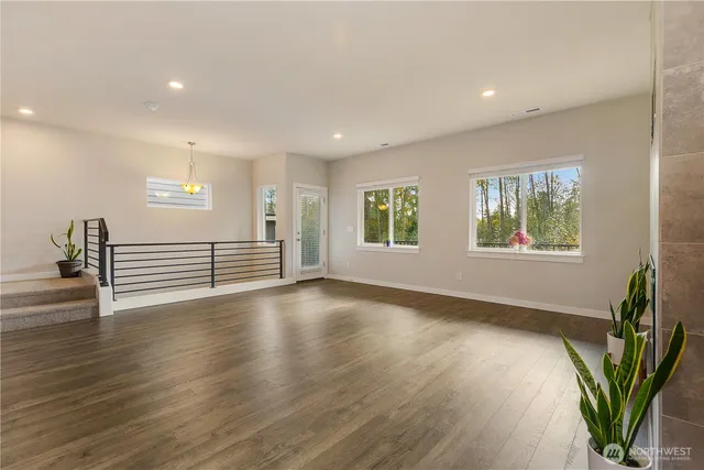 a view of a livingroom with wooden floor and a window