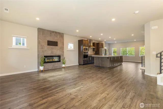 a view of kitchen and hall with wooden floor