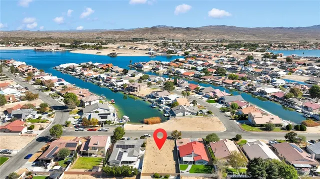 an aerial view of residential houses with outdoor space and seating