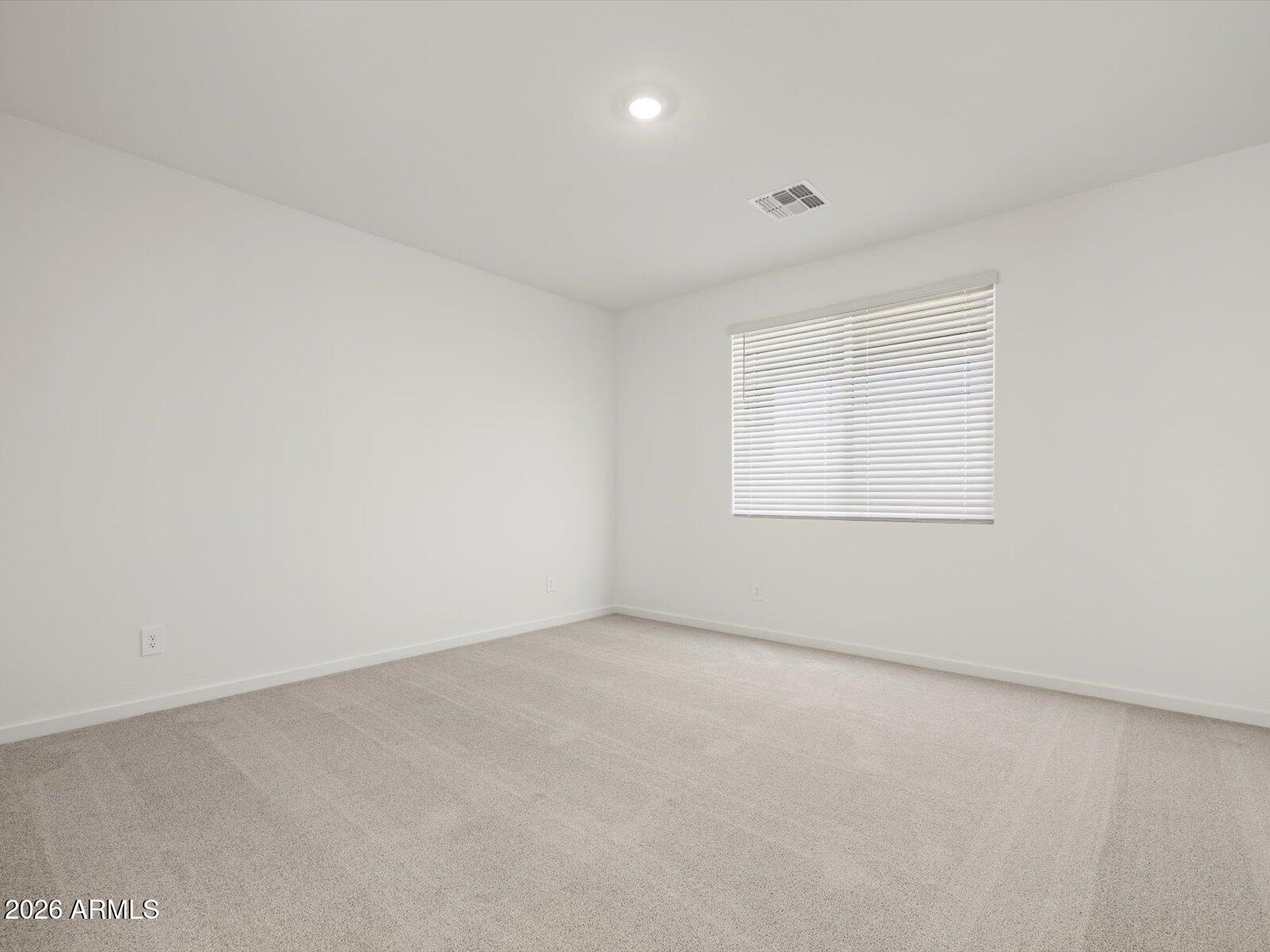 2380 Grenache Road San Tan Valley, AZ 85143 - Photo 11 of 78 an empty room with a empty space and windows