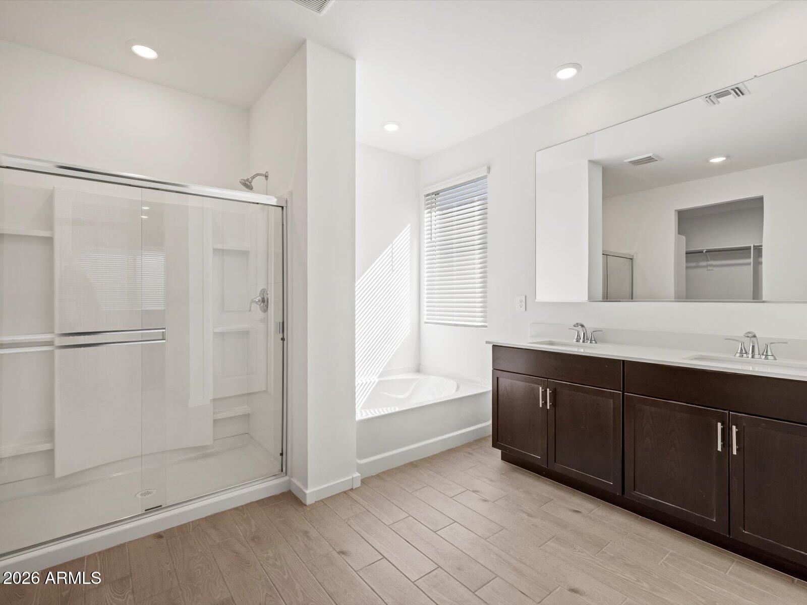 2380 Grenache Road San Tan Valley, AZ 85143 - Photo 13 of 78 a bathroom with a double vanity sink a large mirror and shower