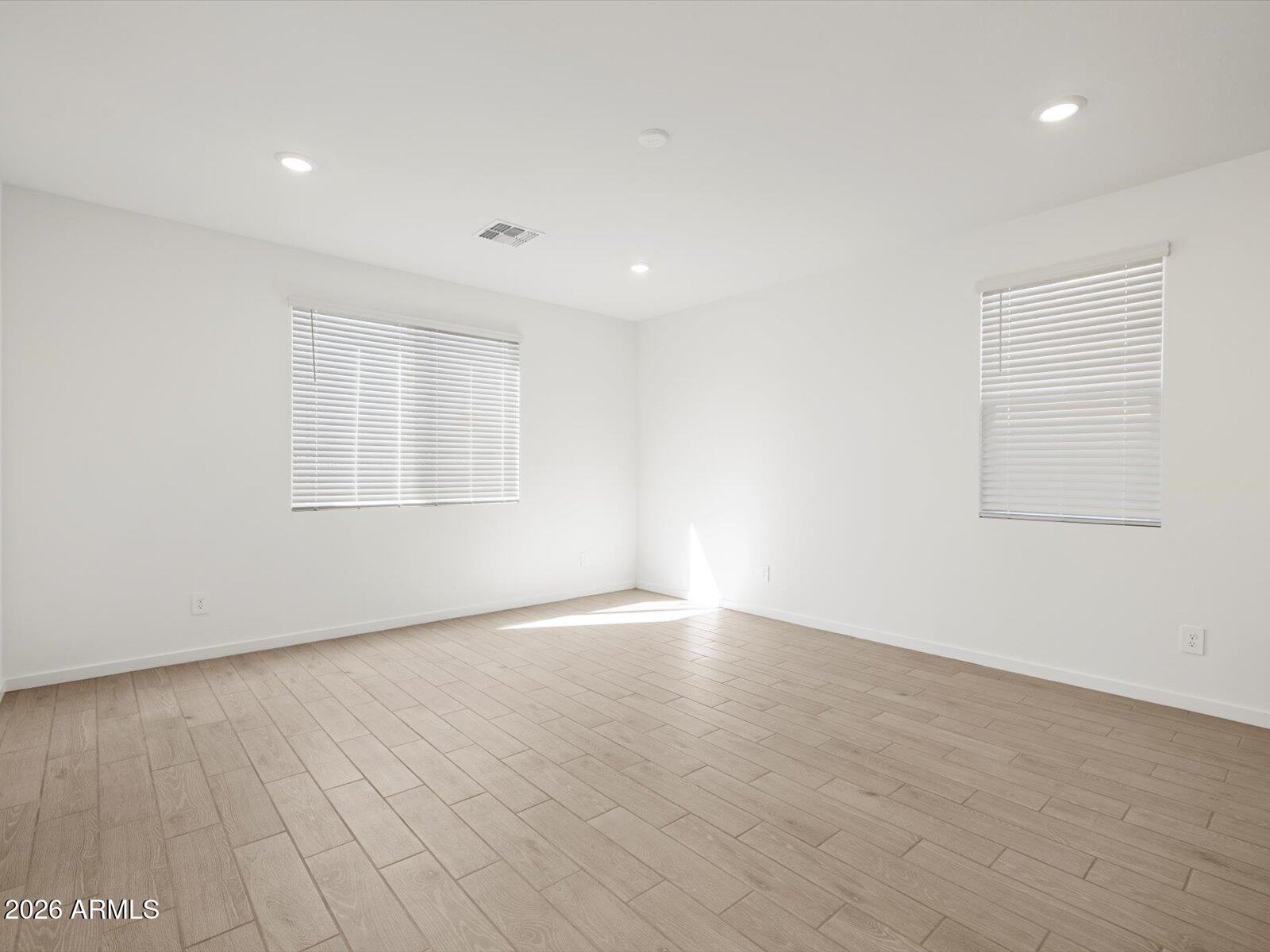 2380 Grenache Road San Tan Valley, AZ 85143 - Photo 16 of 78 an empty room with wooden floor and windows